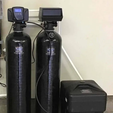 Dual-tank water softener system by Optimal Plumbing Solutions with digital control valve.