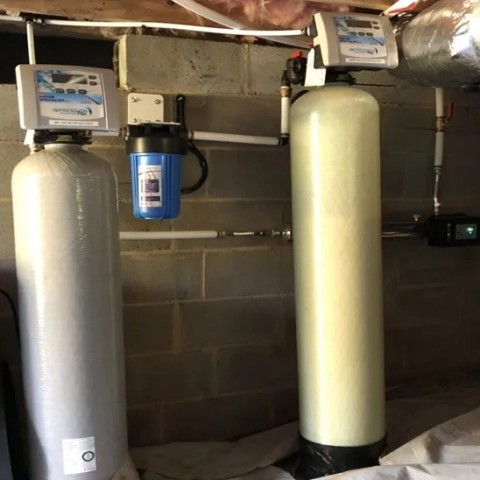 Water Specialist Inc. Impression Plus water softener and acid neutralizer system in a basement.