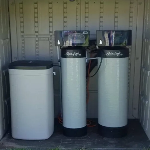RainSoft EC4 Water Softener System with dual tanks and brine tank in a protective outdoor enclosure.