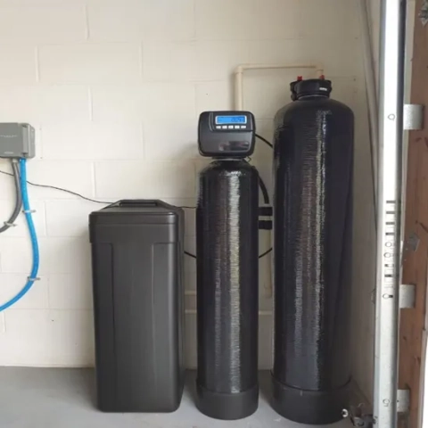 Water Guys water softener system with digital control valve and dual black filtration tanks.