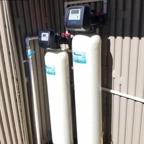 Dual tank Watertech Inc. water softener with digital control valves for home filtration.