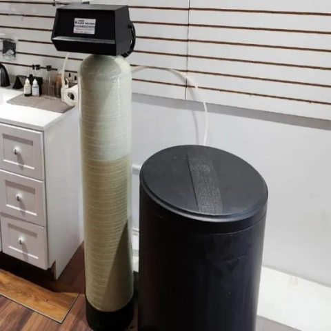 Water treatment system with fiberglass resin tank and brine tank, used for residential hard water softening.
