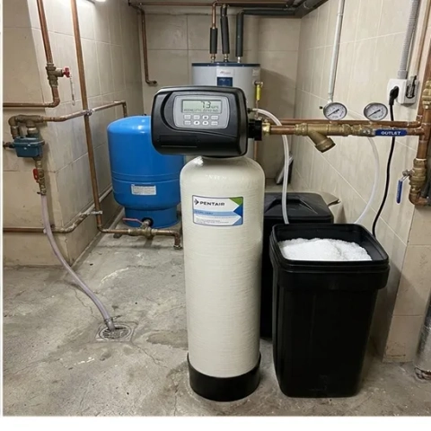 Pentair water softener system with digital control valve and brine tank for home water treatment.