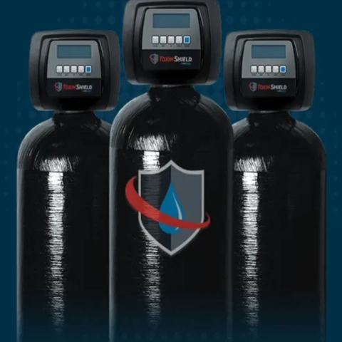 Toxin Shield water filtration tanks featuring digital control valves and a protective shield logo.