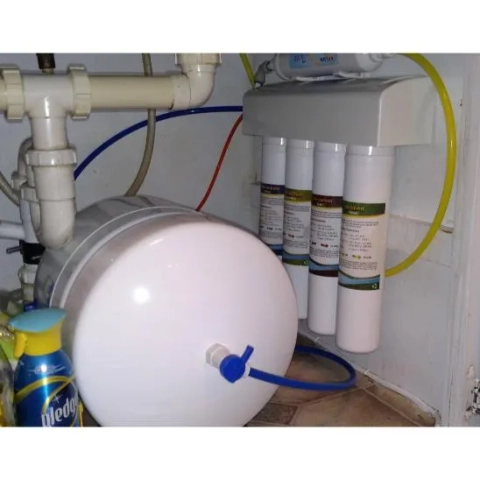 Under-counter WaterServ RO system with multi-stage filters and pressurized water storage tank.