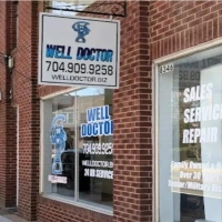 Exterior sign for Well Doctor, a family-owned company offering emergency well pump sales and repair services.
