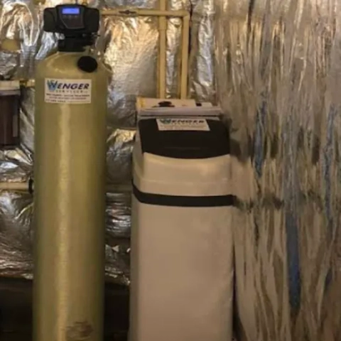 Household ion-exchange water conditioning system installed in a residential utility room with insulated walls by Wenger Services LLC