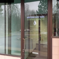 Exterior view of the Western New York Environmental Consulting Firm office entrance with business name and logo