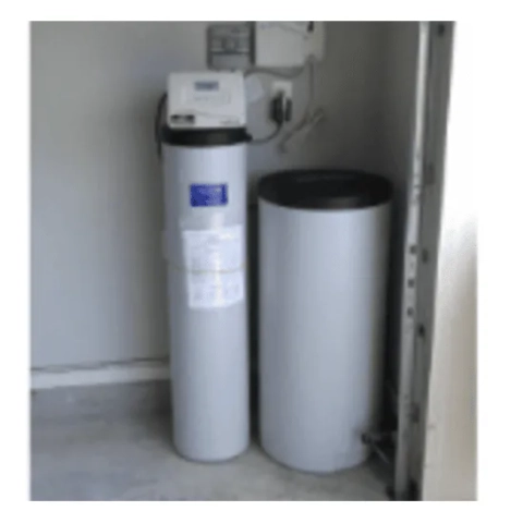 Professional whole-house ion-exchange water softener system cleanly integrated into a residential basement utility zone by Your 1 Plumber