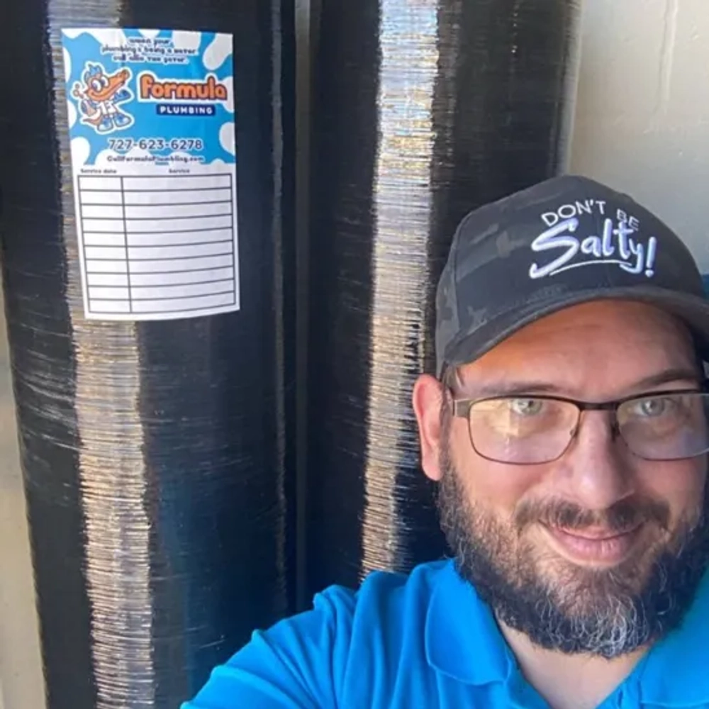 Formula Plumbing dual-tank water treatment system combining softening resin and activated carbon filtration