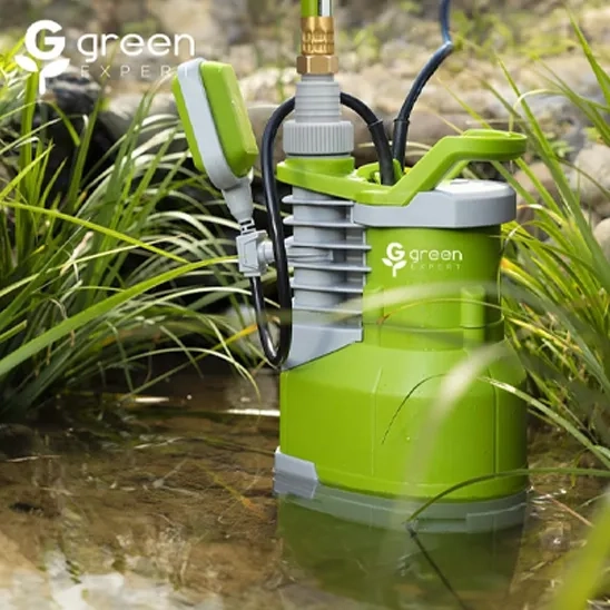 Green Expert submersible water pump with float switch operating in a garden pond for rapid drainage.