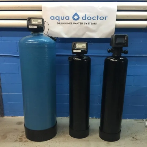 Aqua Doctor Drinking Water Systems water softeners with blue and black tanks and digital meters.
