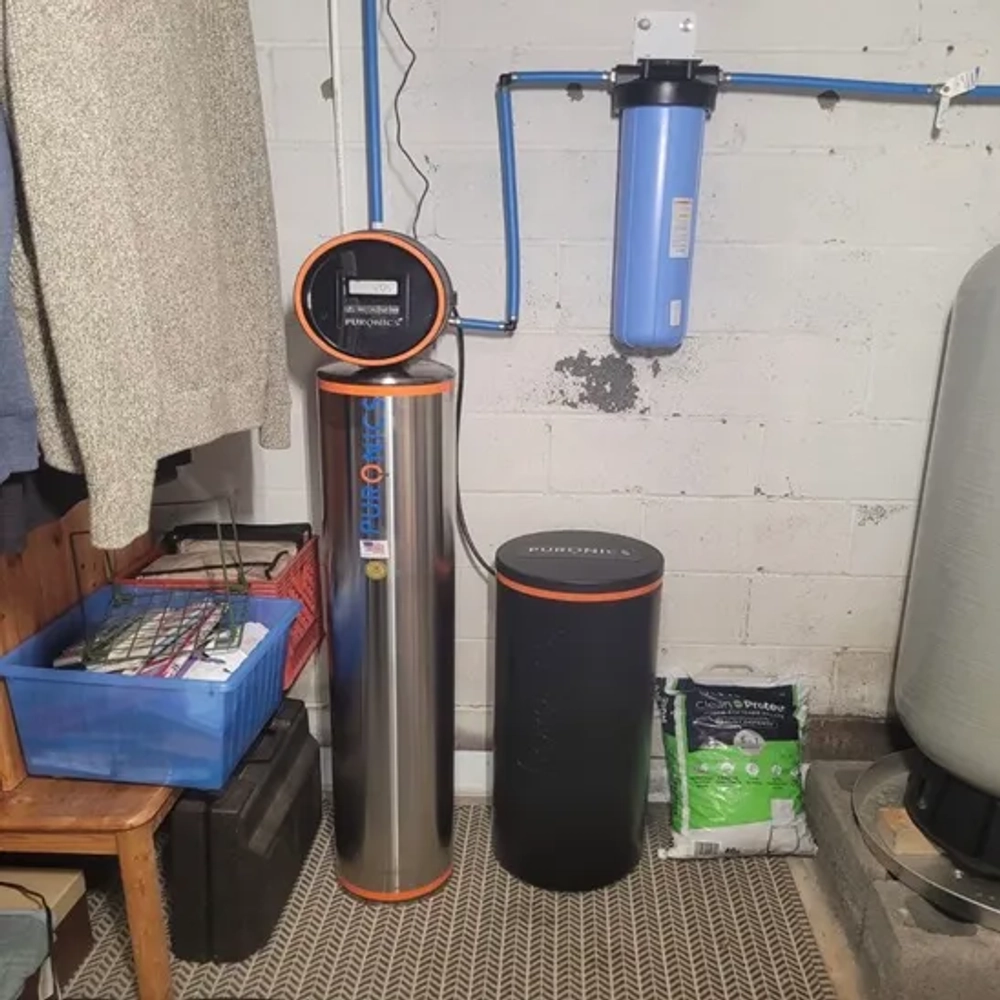BEMOR installed Puronics chrome water softener with pre-filter and digital meter in a laundry area.