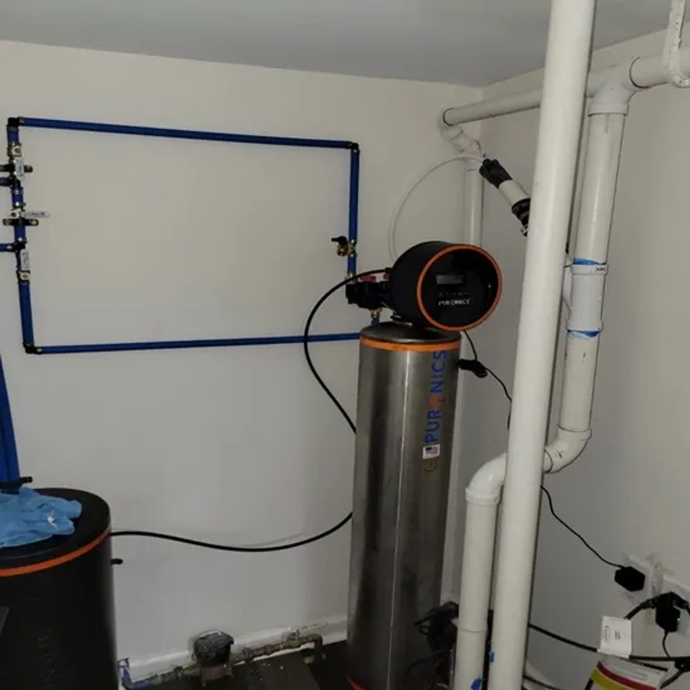 Puronics chrome tank water softener with digital meter and PEX bypass loop installed by BEMOR.